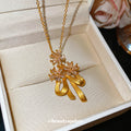 Gold Tone Bow And Flower Pendant Necklace With Teardrop Charms view 3