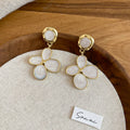 White Four Petal Drop Earrings with Gold Tone Outlines view 6