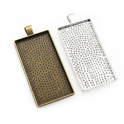 Overview of long rectangular pendant trays with dotted textured backs on a light background