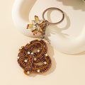 Beaded Bronze Knot Keychain With Rhinestone Flower Charm view 3