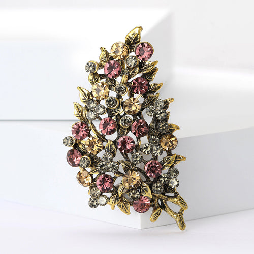 Close-up product view showing the colors and surface details of the clustered crystal leaf brooch