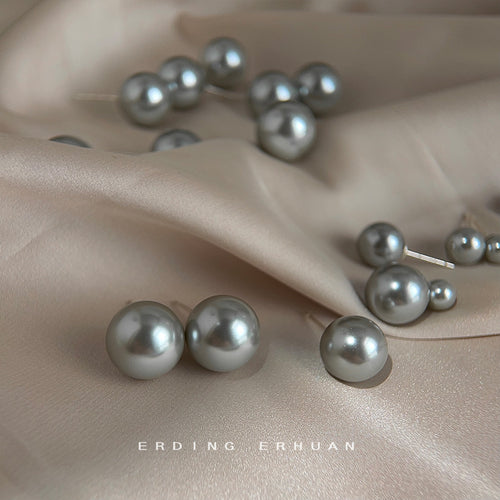 Grey pearl studs grouped on beige satin