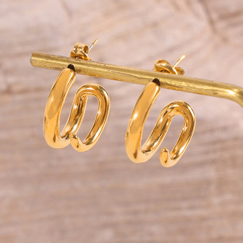 Gold C-shape twisted hoop studs hanging on metal rod