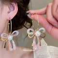 Pink Iridescent Bow Dangle Earrings With Gold Tone Hooks view 1