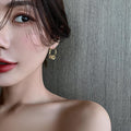 Gold Tone Twisted Hoop Earrings With Crystal Barrel Charms view 2