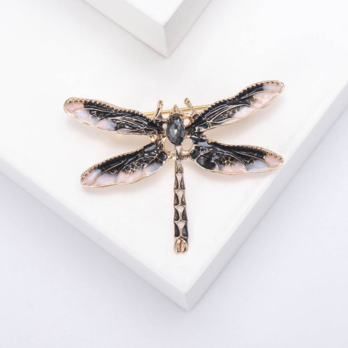 Red enamel dragonfly brooch close front on white block