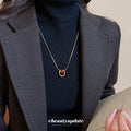 Red Teardrop Gold Tone Necklace With Polished Metal Tone Details view 3