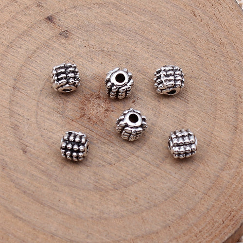 Grid Texture Barrel Spacer Bead in Antique Silver Metal shown in image 2, highlighting a compact barrel profile and rais