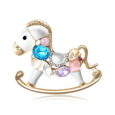 Front view of the jeweled rocking horse brooch in black and white enamel brooch and its color options
