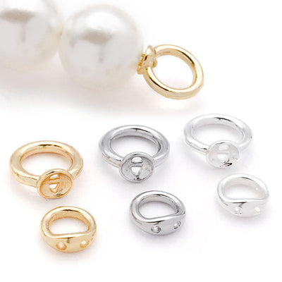 Double hole metal connector rings in two sizes arranged as a full product overview