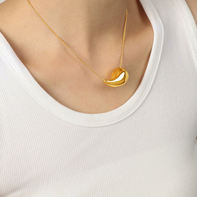 Gold teardrop pendant snake chain on white tank neckline