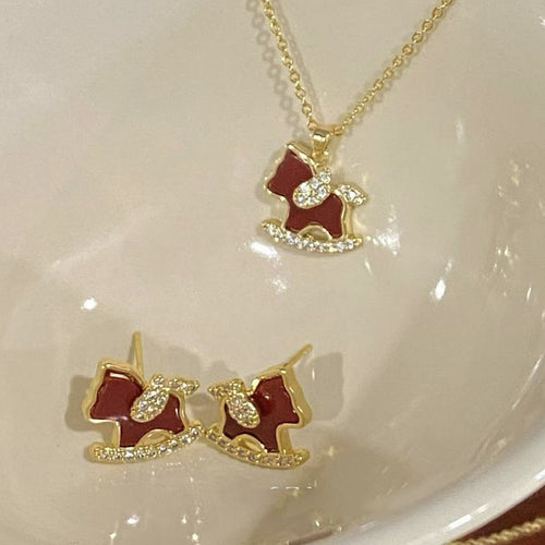 Gold red enamel CZ rocking horse necklace and stud earrings close-up