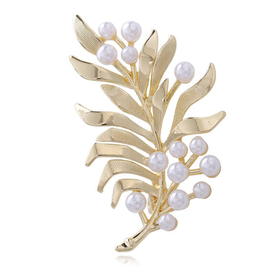 Front product view of the gold and pearl brooch