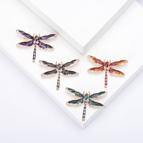 Four enamel dragonfly brooches red black green purple display