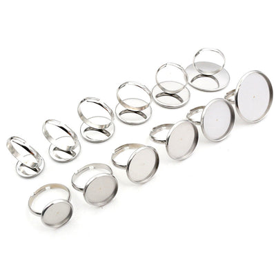 Assorted silver-tone round cabochon ring blank settings for crafts arranged together in the main product view