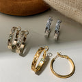 Textured Crossover Hoop Earrings In Polished Gold Tone view 1