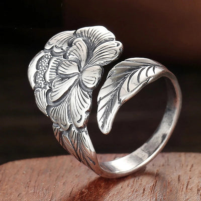 Antique silver peony flower leaf open ring on wood surface
