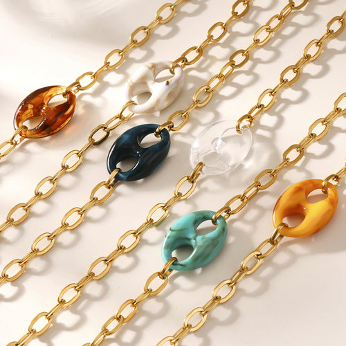 Six resin mariner pendants on gold chains flat lay mixed colors