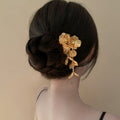 Gold Tone Floral Hair Pin With Textured Petals And Long Leaf Drop view 2