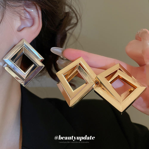 open diamond frame stud earrings in gold and silver tone shown in an on-ear styling view
