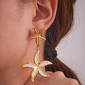 Gold Dual Starfish Drop Earrings with White Enamel Inlay view 4