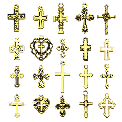 Gold-tone cross charms arranged on a light background