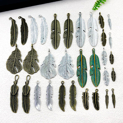 Metallic leaf charms arranged on a light background