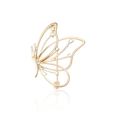 Gold openwork butterfly brooch with heart wing details front view