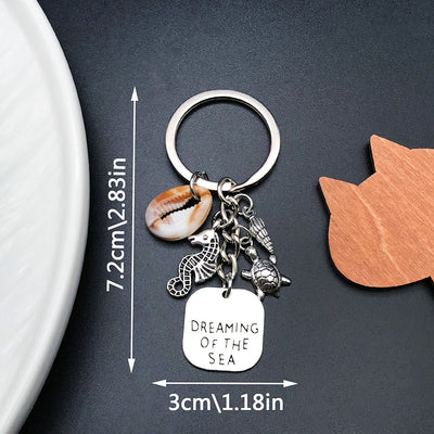 Front product photo of antique silver seahorse turtle shell and message plaque keychain showing the pictured design arra