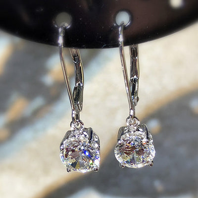 Product view showing silver-tone round clear solitaire leverback drop earrings