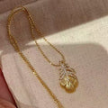 Gold Tone Textured Feather and Crystal Pendant Necklace view 1
