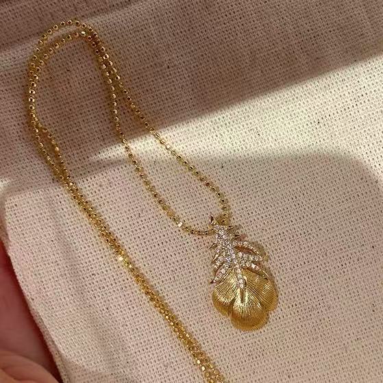 Gold Tone Textured Feather and Crystal Pendant Necklace