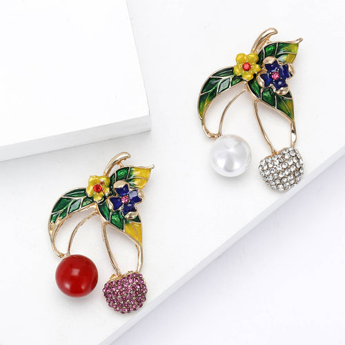 Front view of the cherry brooch with enamel leaves and crystal flowers on a white background