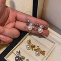Bow and Pearl Stud Earrings in Gold and Dark Silver view 3