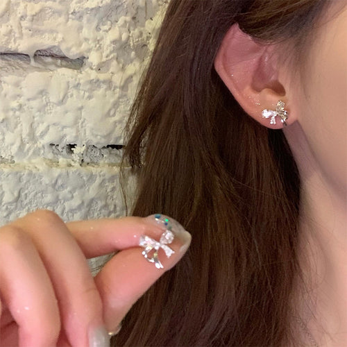 Silver Tone Crystal Bow Stud earrings shown worn at the ear