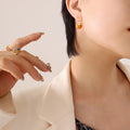 Gold Steel Crescent Bag Shape Textured Hoop Earrings view 1