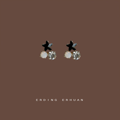 Mini black star dual stone studs on solid brown background