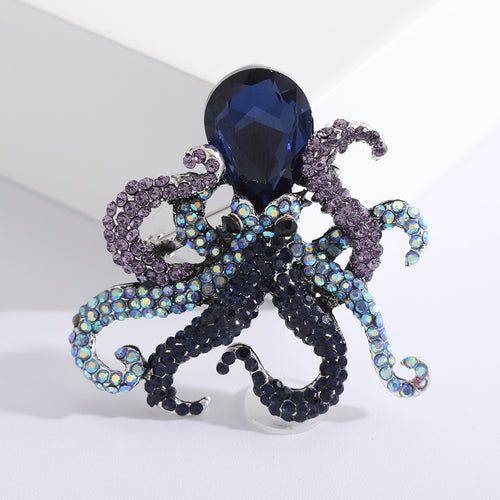 Blue crystal head octopus brooch with purple iridescent tentacles