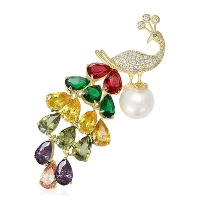 Product display showing a gold-tone peacock with layered colored crystals and a white pearl drop