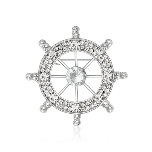 An open ship wheel outlined with clear crystals shown in a styled display.