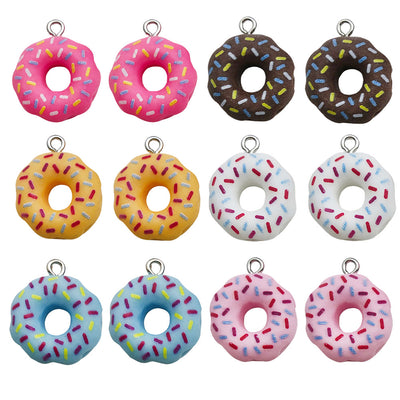 Multicolor donut charms arranged on a light background
