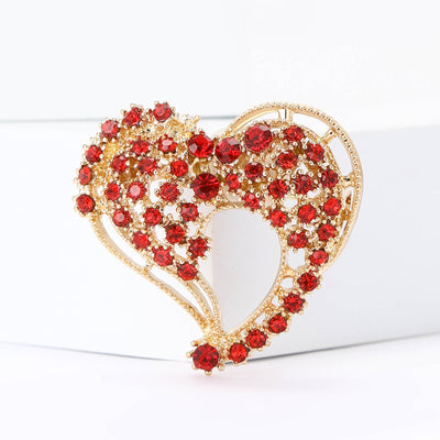Front view of two interlocking gold-tone hearts outlined and filled with red crystals