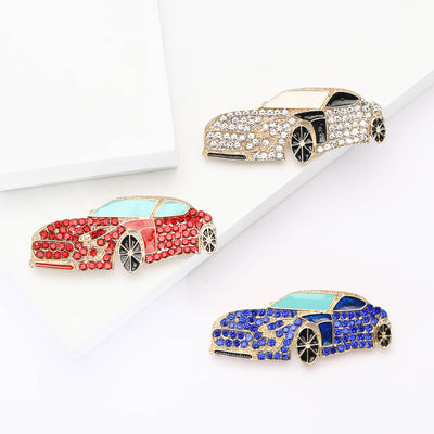 Front view of a low sports car covered with rows of small crystals