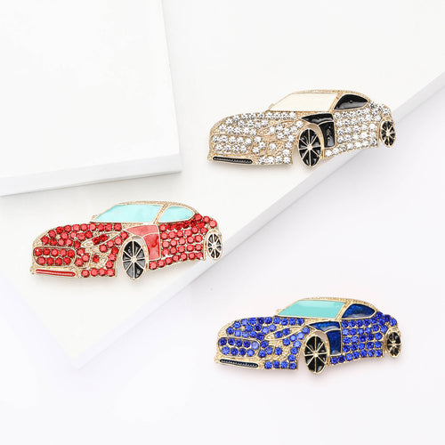 Front view of a low sports car covered with rows of small crystals