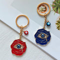 Red and Navy Rose Blue Evil Eye Metal Keychains in Two Styles view 1