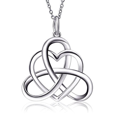 Silver Celtic heart knot pendant necklace on white reflective surface