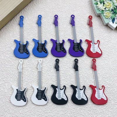 Colorful musical instrument and guitar charms arranged on a light background