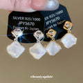 Gold Tone Diamond White Shell Look Drop Clip On Earrings view 1