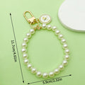 White Beaded Wristlet Keychain with Rose and Butterfly Charms view 3
