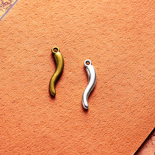 Main product image of the curved chili pepper charm showing a slim curved chili pepper shape with a small top loop